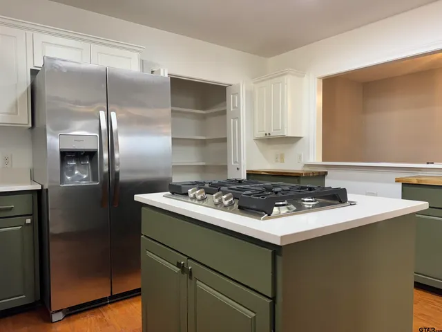 a stove top oven sitting inside of a kitchen