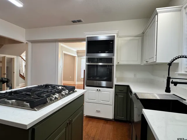 a kitchen with a stove and a refrigerator