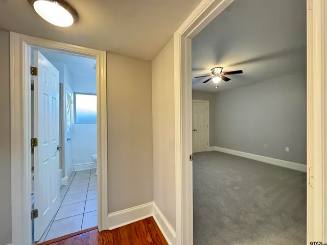 a view of an empty room with a ceiling fan