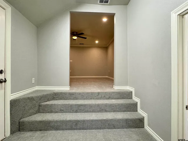 a view of an empty room with a ceiling fan