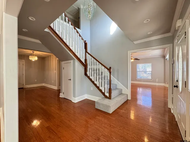a view of entryway and hall with wooden floor