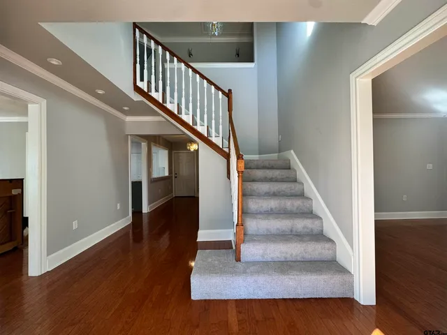 a view of entryway and hall with wooden floor