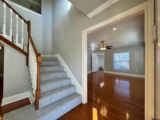 a view of entryway and hall with wooden floor
