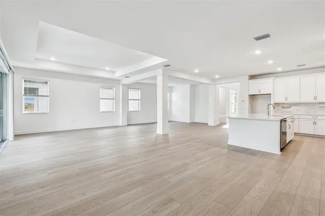 a view of kitchen with wooden floor and electronic appliances