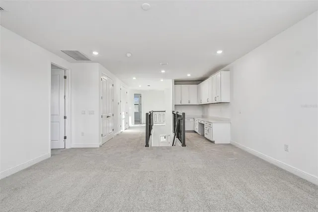 a view of a kitchen with a sink and cabinets
