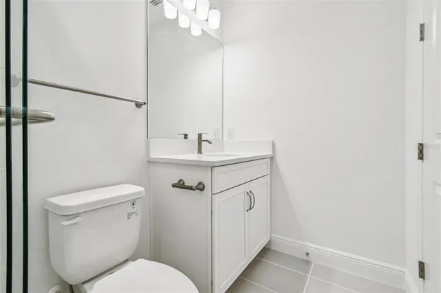 a white toilet sitting next to a bathroom sink