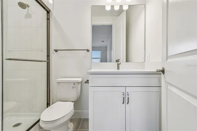 a bathroom with a toilet a sink and a mirror