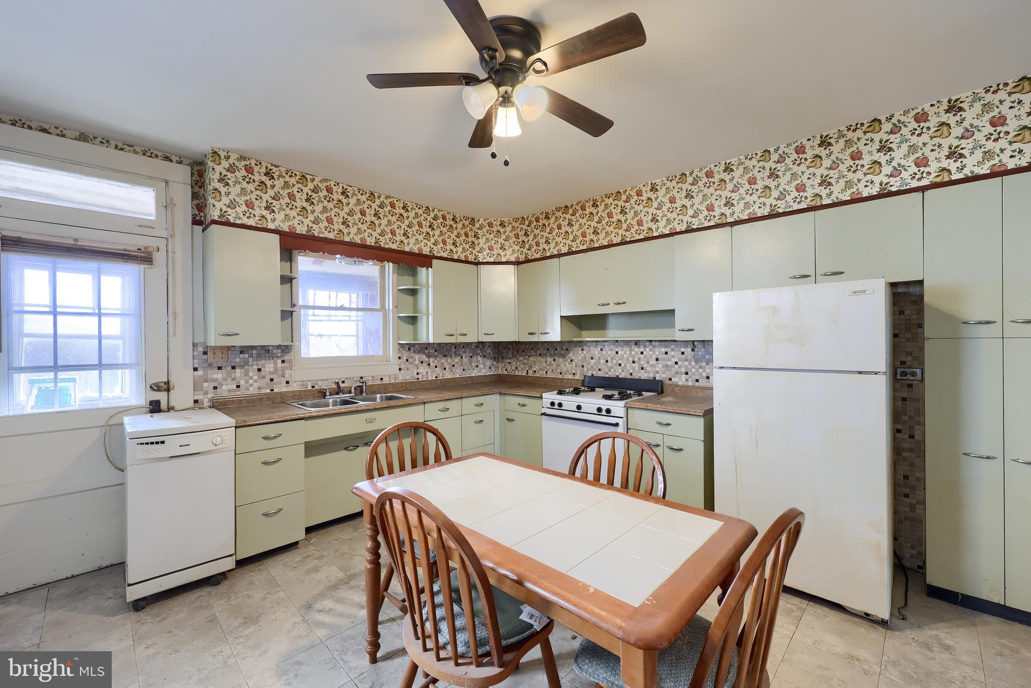 14 West New Street Lancaster, PA 17603 - Photo 11 of 21 a kitchen with stainless steel appliances granite countertop a refrigerator a sink a stove a dining table and chairs