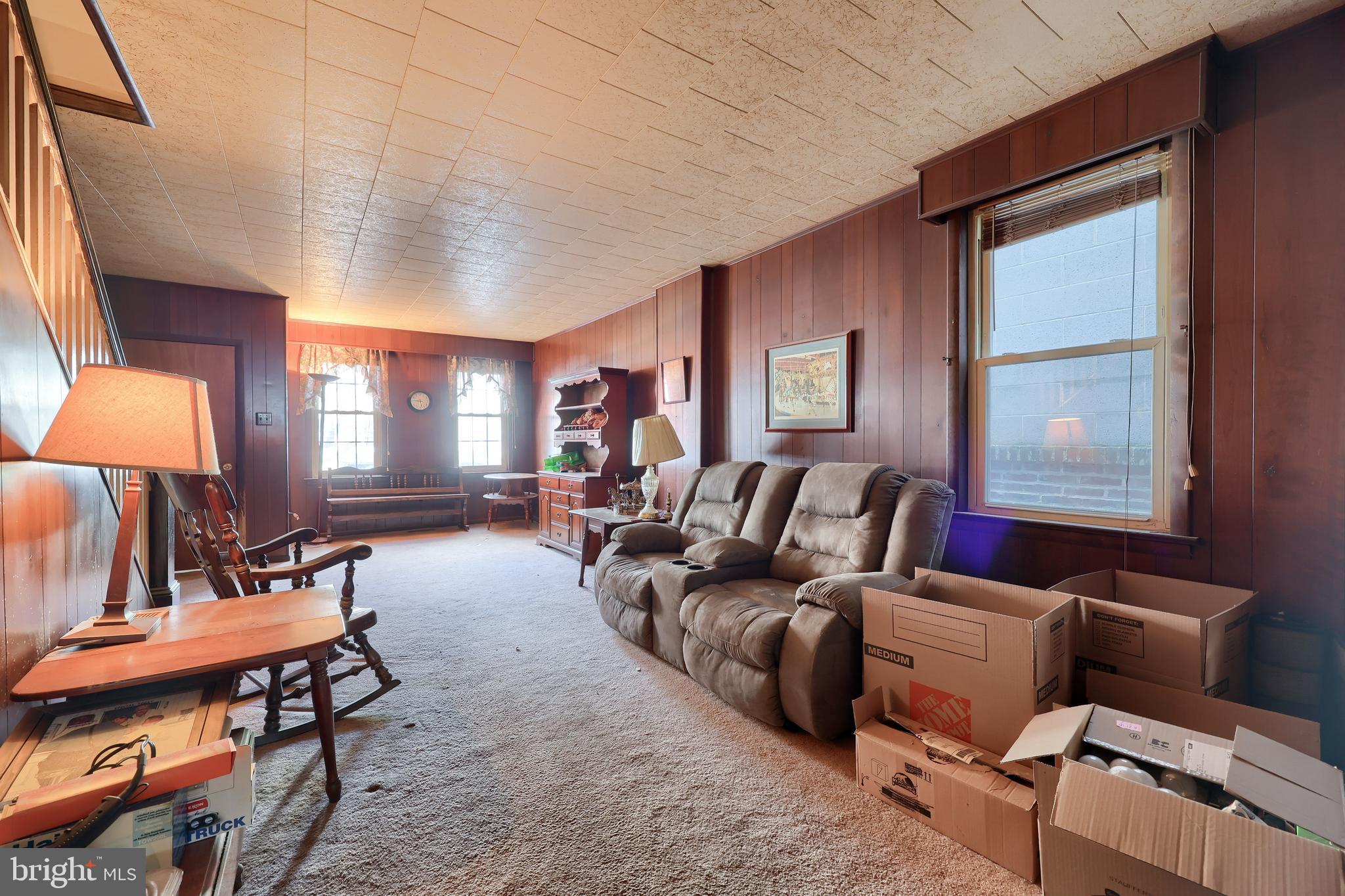 14 West New Street Lancaster, PA 17603 - Photo 6 of 21 a living room with furniture a lamp a rug and a window