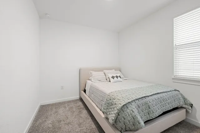 a bedroom with a bed and a mirror