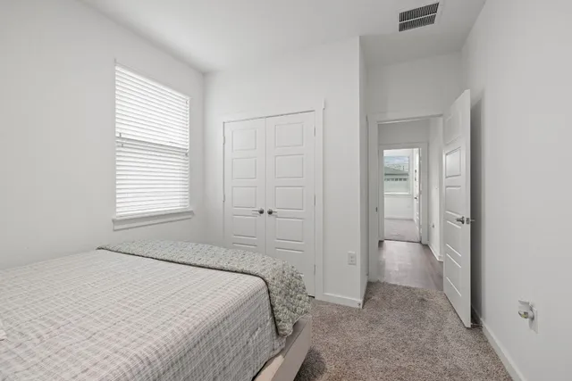 a bed sitting in a bedroom and wooden floor
