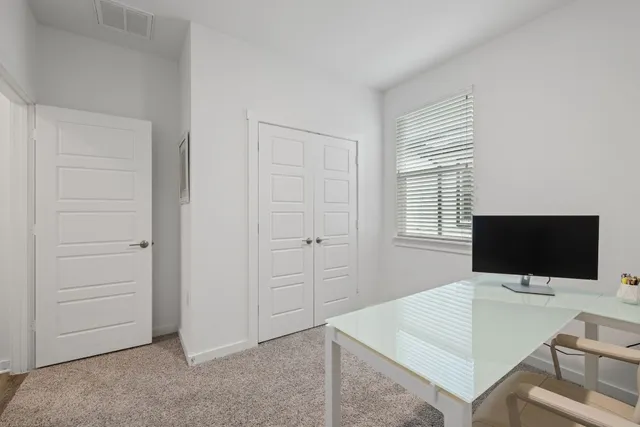 a bedroom with a bed and large window
