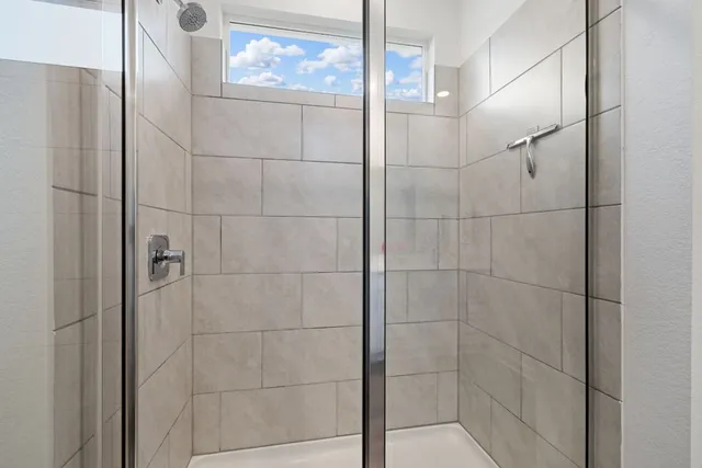 a kitchen with stainless steel appliances granite countertop white cabinets and a stove top oven with granite countertops