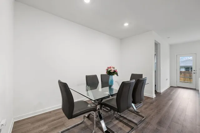 a view of a workspace with furniture and wooden floor