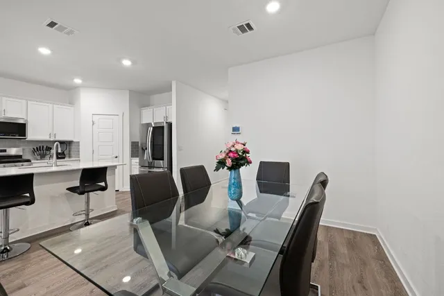 a kitchen with a sink a counter top space stainless steel appliances and cabinets