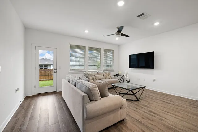 a living room with furniture and a large window