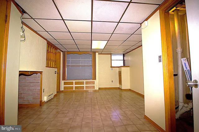 a view of empty room with wooden floor and windows