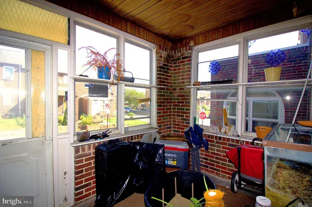 a dining room with furniture and a floor to ceiling window
