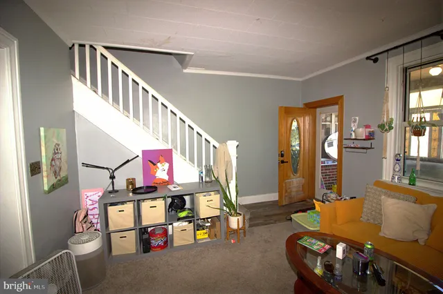 a bedroom with furniture and a wooden floor