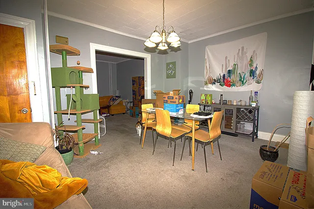 a view of a dining room with furniture and a chandelier
