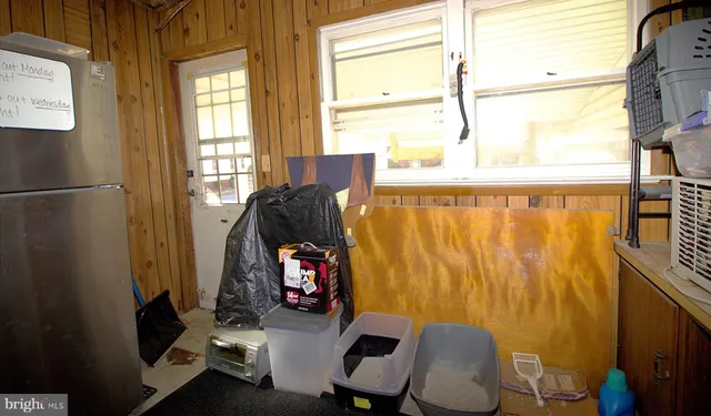 a view of a bedroom with furniture and a window