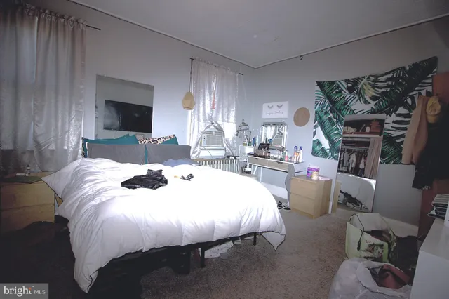 a bed room with a bed and a chair