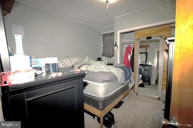 a bedroom with a bed and a mirror