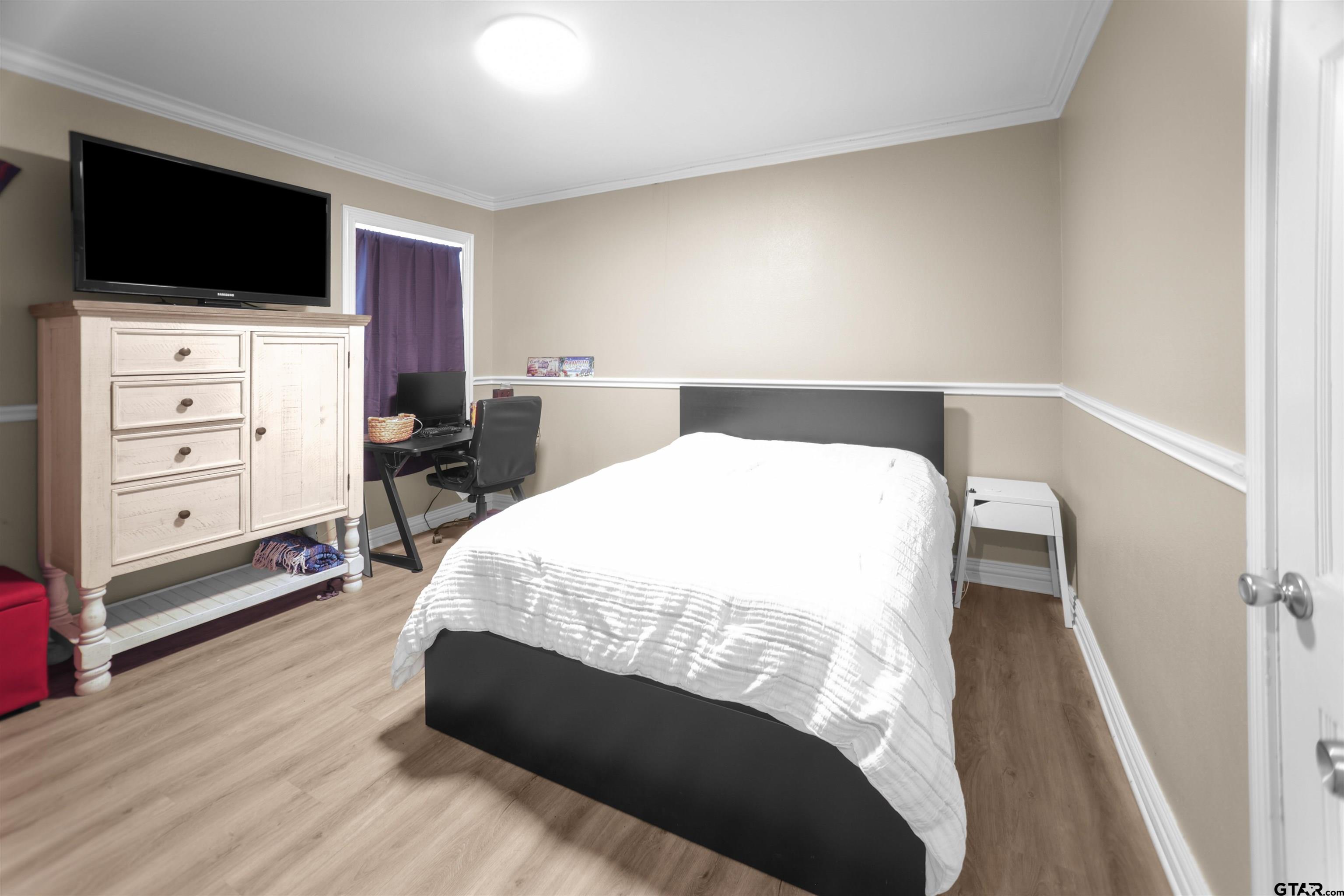 11931 State Highway 64 Tyler, TX 75704 - Photo 17 of 44 a bedroom with a bed and a flat screen tv