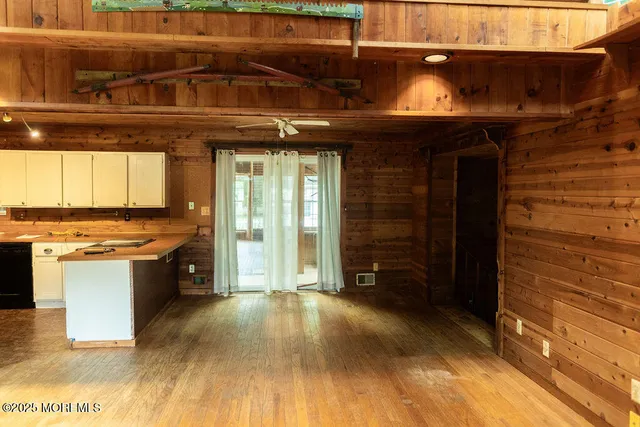 a view of a room with wooden floor