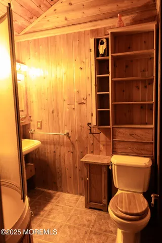 a view of a tennis ground with large trees