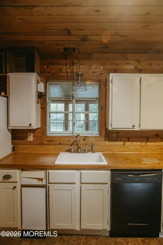 a large kitchen with a wooden floor and a stove top oven