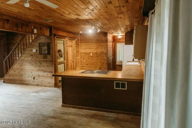 a view of a hallway with wooden floor and a fireplace