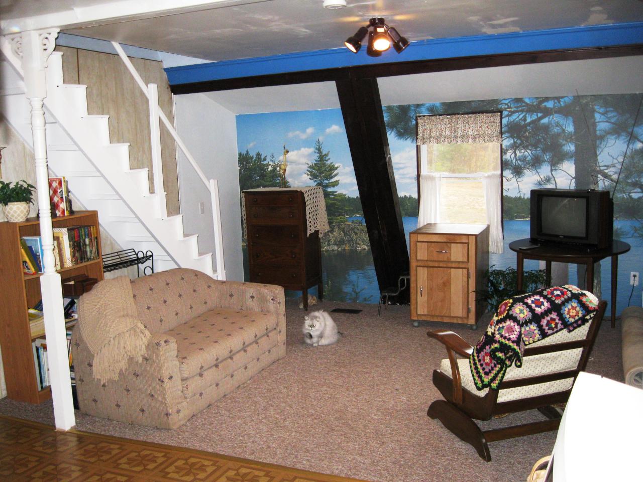 648 East Otis Road Otis, MA 01253 - Photo 6 of 15 a living room with furniture a flat screen tv and a floor to ceiling window