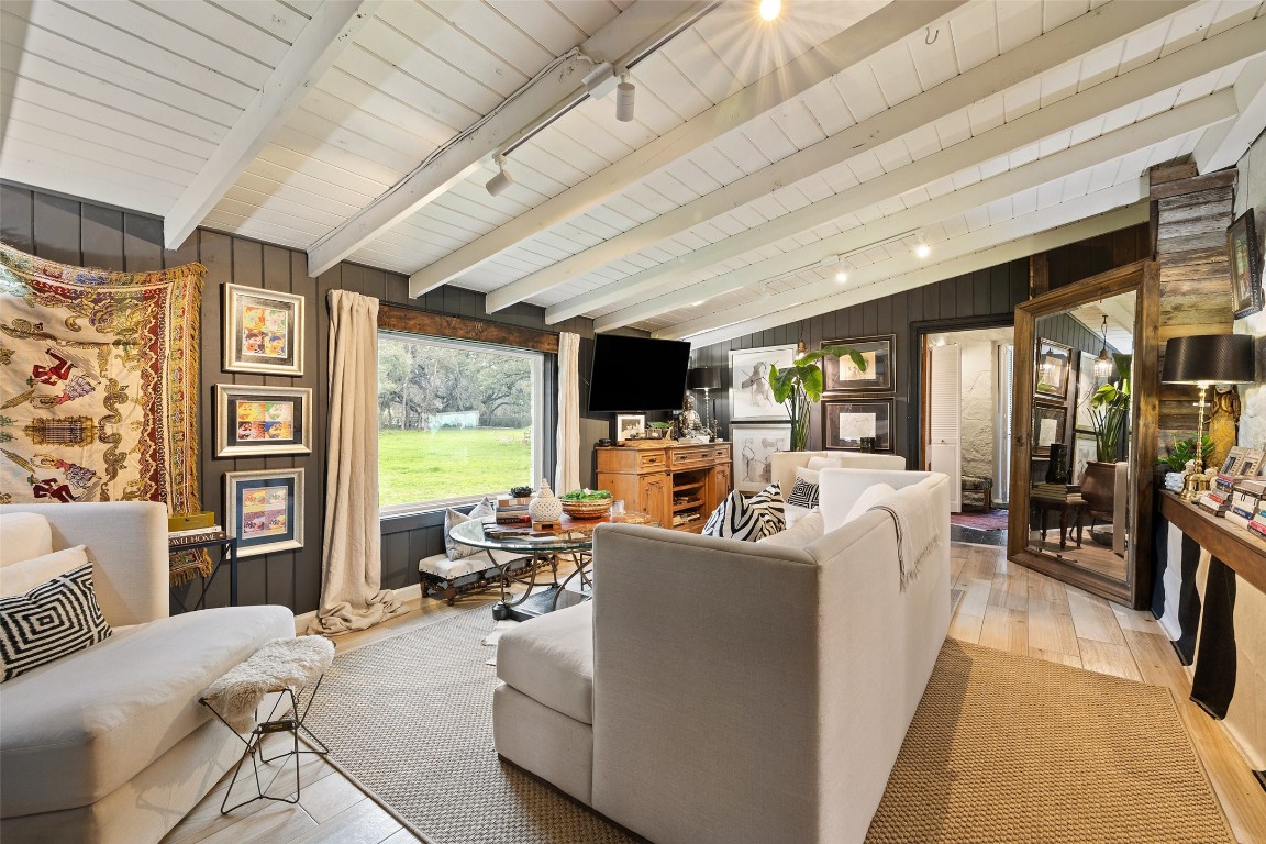 400 Lange Road Wimberley, TX 78676 - Photo 11 of 25 a living room with furniture floor to ceiling window and a flat screen tv