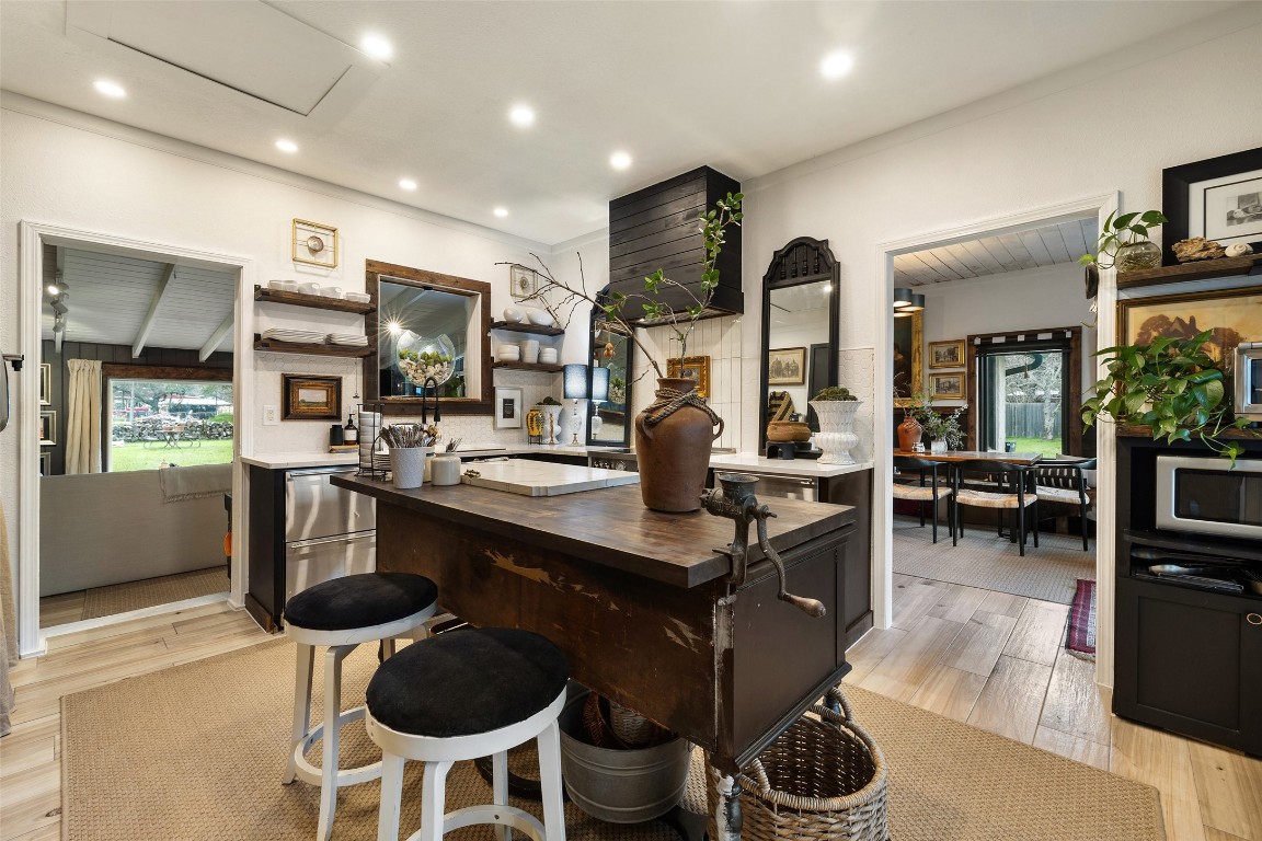400 Lange Road Wimberley, TX 78676 - Photo 9 of 25 a kitchen with stainless steel appliances granite countertop a sink a stove and chairs