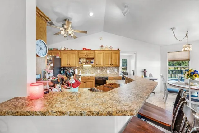 a view of a dining room with furniture a chandelier and wooden floor