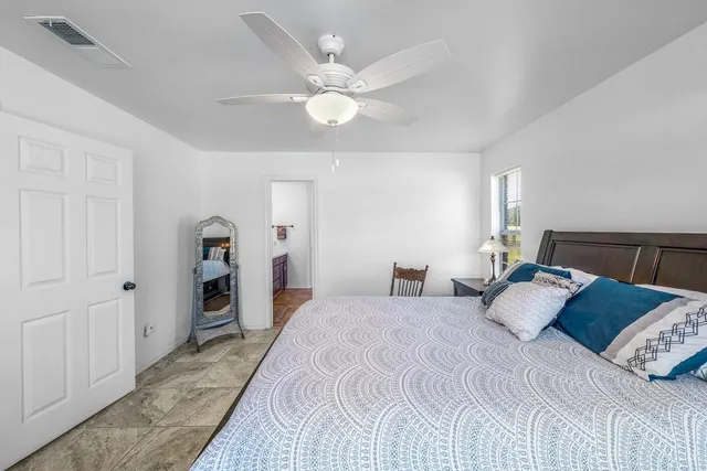 a bedroom with a large bed and a large window