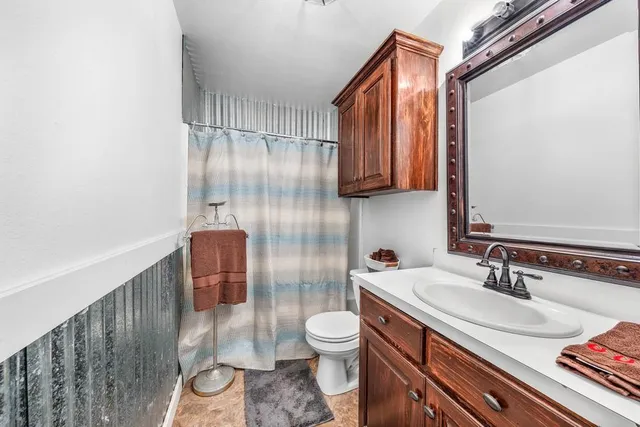 a bed room with a bed and a ceiling fan