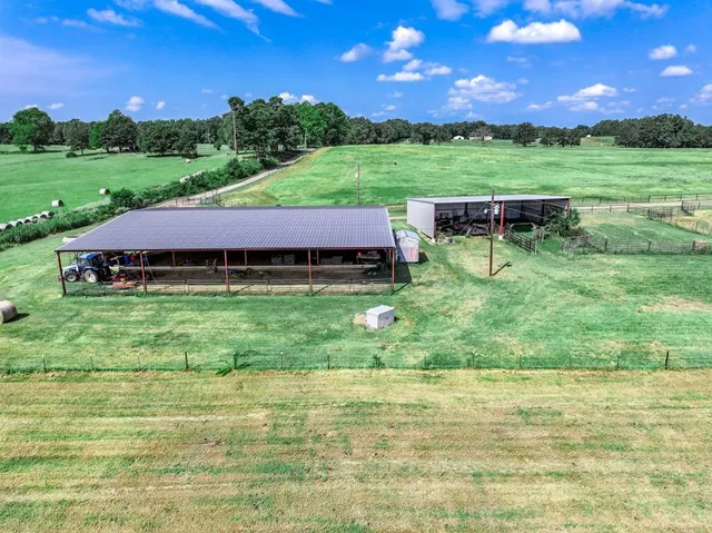 a view of yard with swimming pool and green space