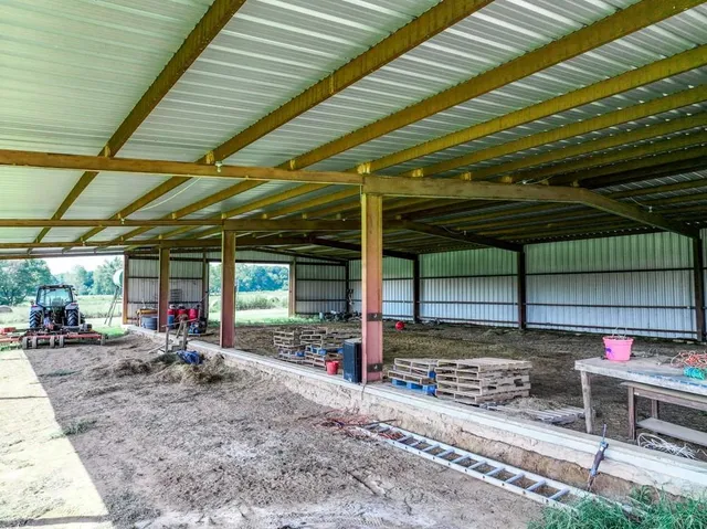 a view of a garage with wooden table and chairs