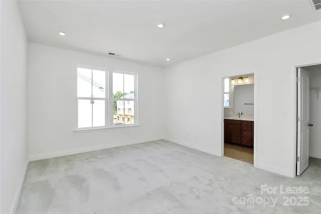 an empty room with windows and closet