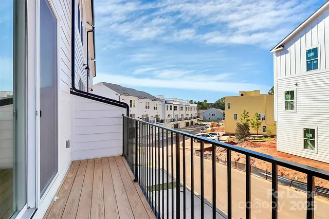a view of a balcony with wooden floor and fence