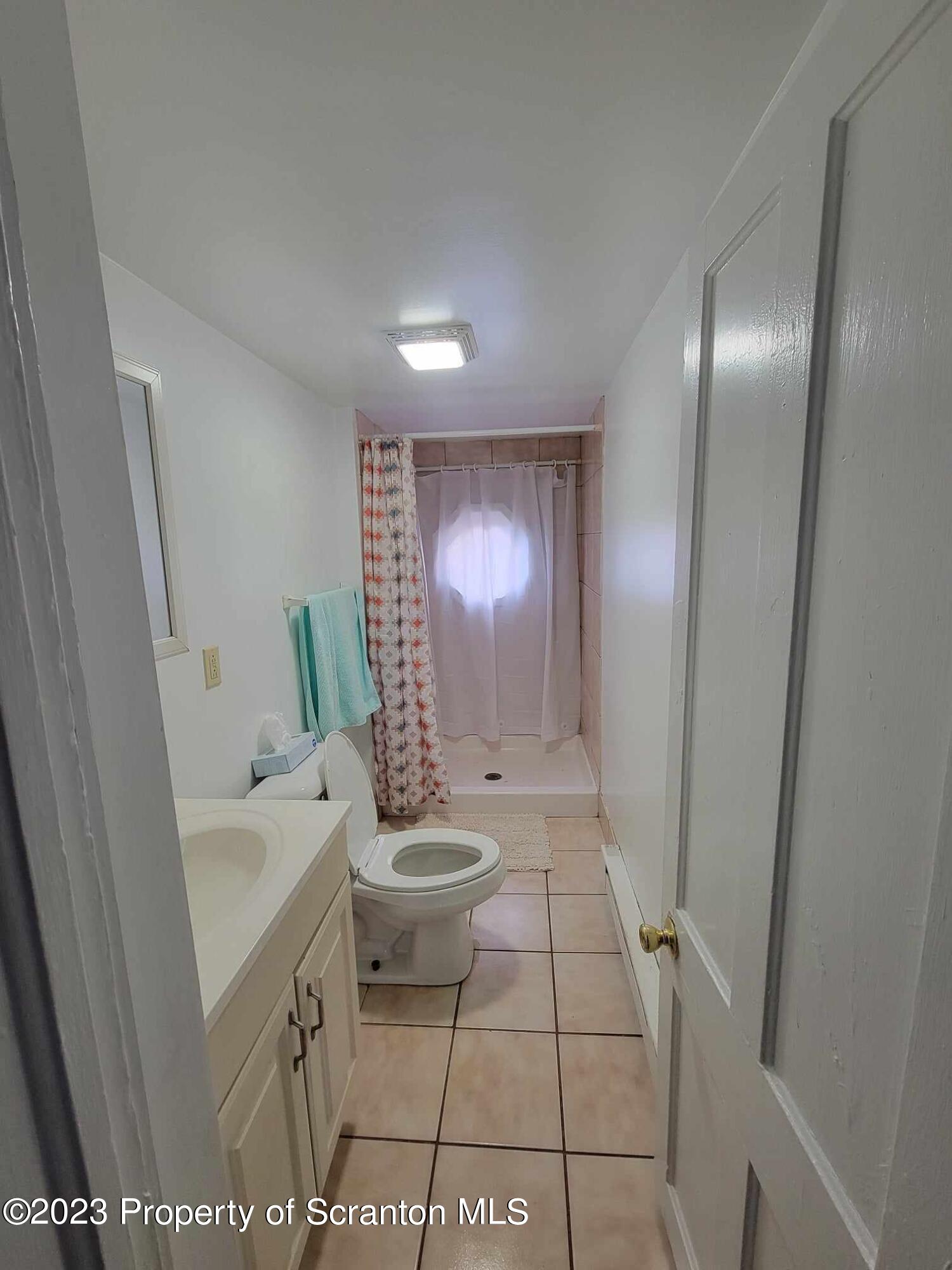 138 East Grove Street Taylor, PA 18517 - Photo 16 of 17 a bathroom with a sink a toilet and a mirror