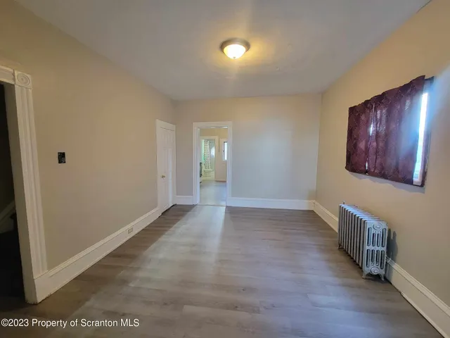 a kitchen with stainless steel appliances granite countertop a refrigerator a sink dishwasher a stove and a dining table