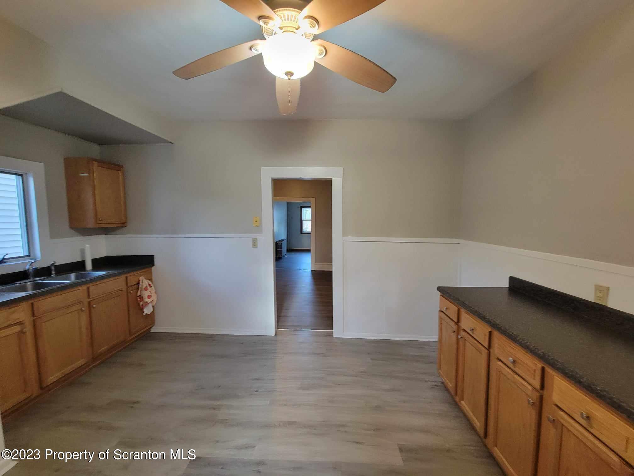 138 East Grove Street Taylor, PA 18517 - Photo 9 of 17 a kitchen with stainless steel appliances granite countertop a refrigerator a sink dishwasher a stove and a dining table
