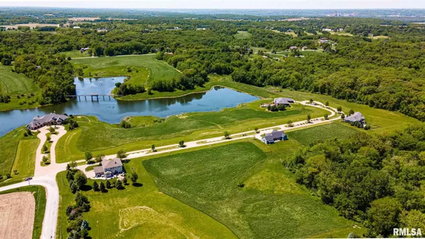 an aerial view of residential houses with outdoor space and swimming pool
