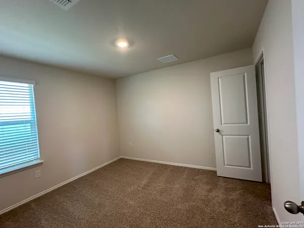 an empty room with a empty space and windows