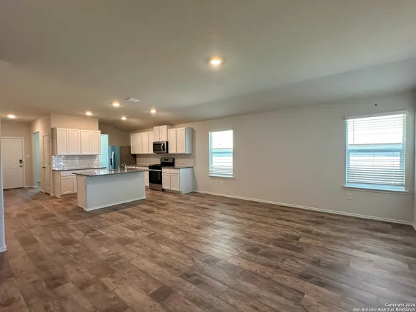 a view of kitchen with kitchen island sink and center island