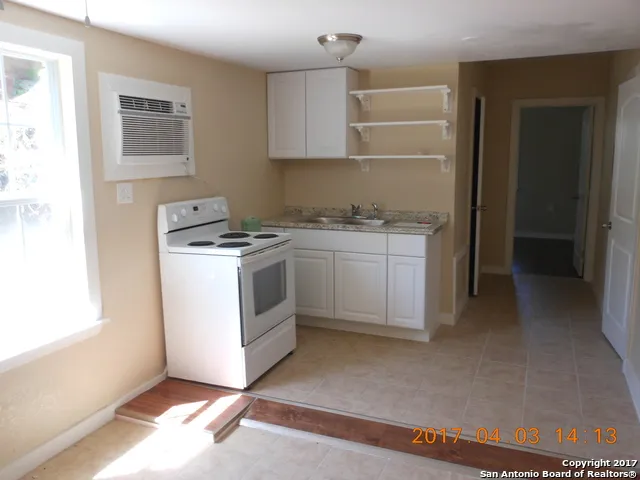 a kitchen with a stove and a refrigerator