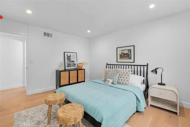 a bedroom with a large bed and a couch